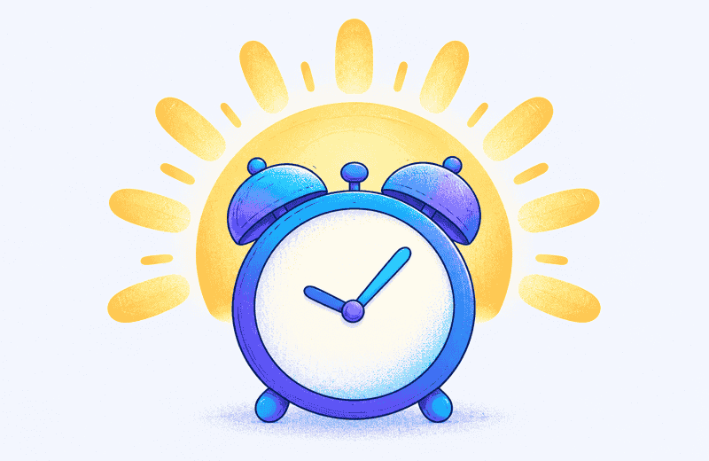Blue twin-bell alarm clock in front of a rising yellow sun